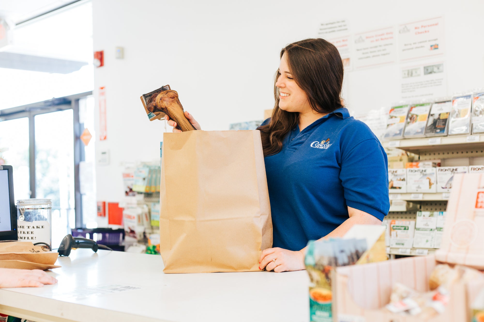 Employee bagging merchandise